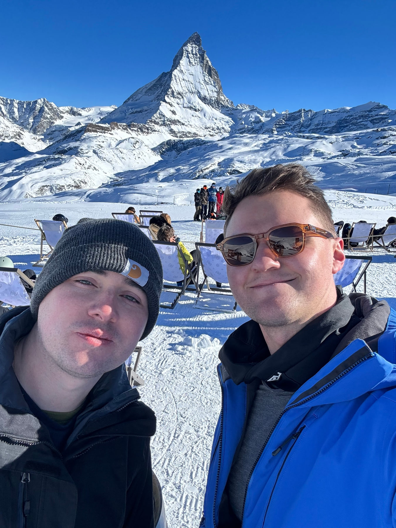 Kyle and his husband skiing with the Matterhorn behind them