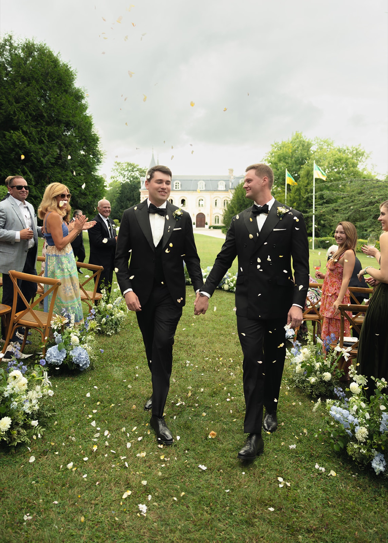 Kyle and his husband walking down the aisle after their wedding ceremony